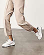Stuart Weitzman,5050 PRO,Sneaker,Leather & knit fabric,Pink,Shoe on tall model