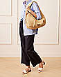 Stuart Weitzman,THE MODA HOBO BAG,Bag,Handwoven raffia,Natural,Shoe on tall model